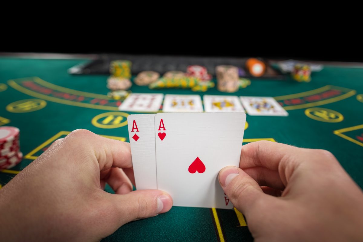 male poker player holding two cards aces Almanbahis Casino